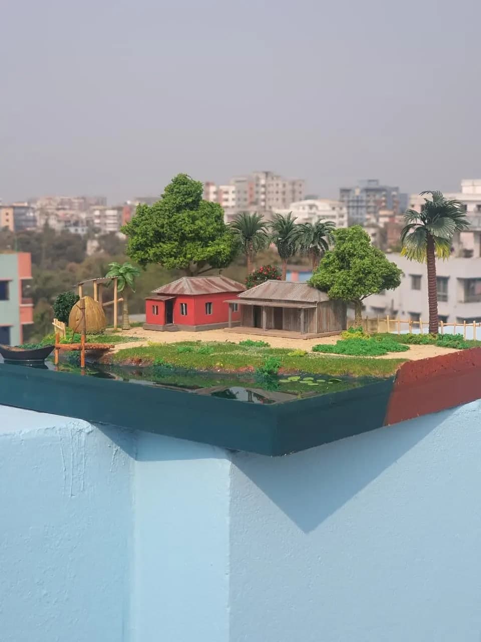 নৌকা ও ঘাটসহ গ্রামের মিনিয়েচার দৃশ্য